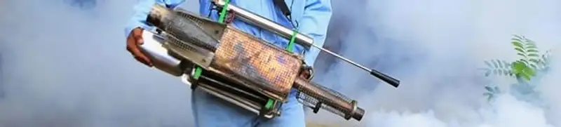 Fumigation technician using a fogger for deep pest treatment in Naperville, IL